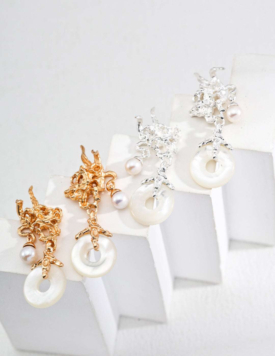 Baroque Aurora — iridescent mother‑of‑pearl shards in tarnished silver and gold, close-up